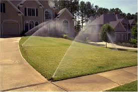 Sprinklers running in front of upscale Volusia County homes